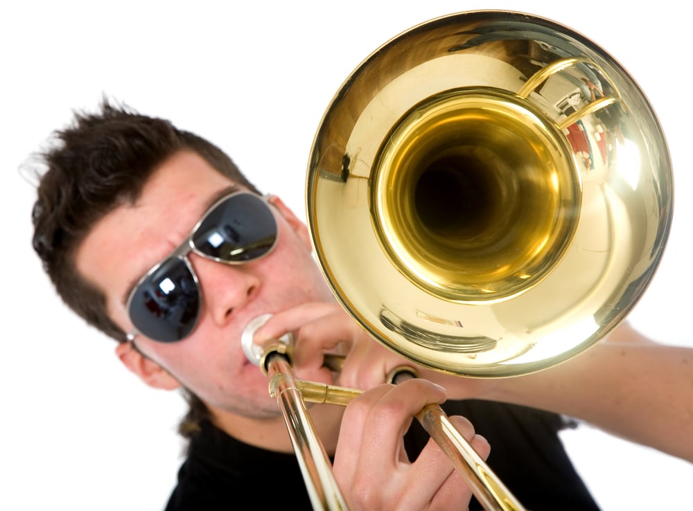 guy playing a trumpet isolated over a white background