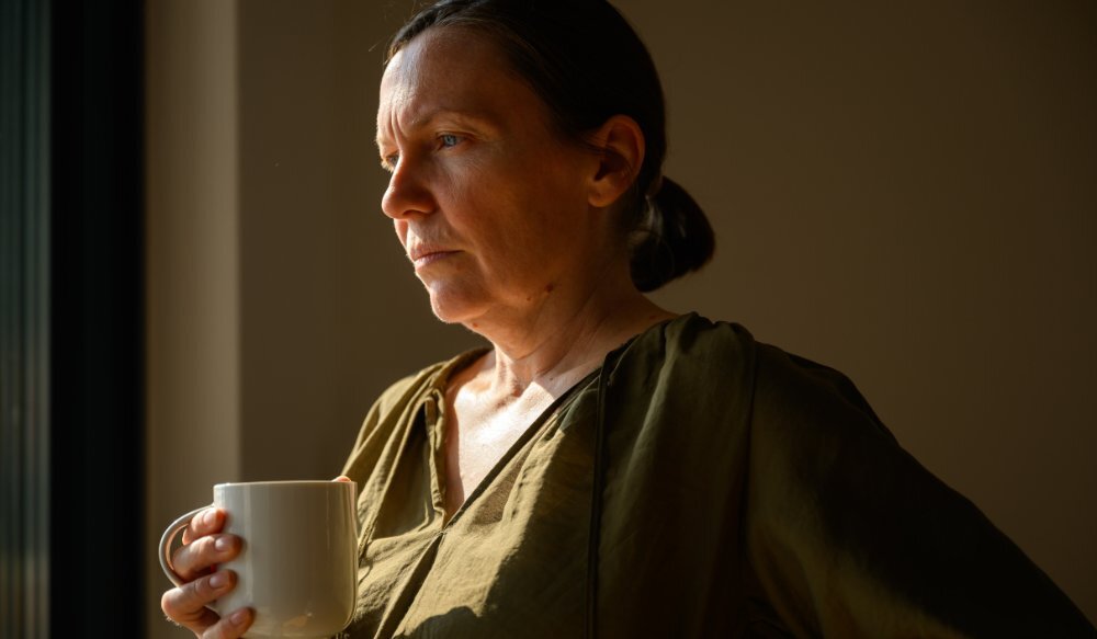 Side profile portrait of mature woman holding mug