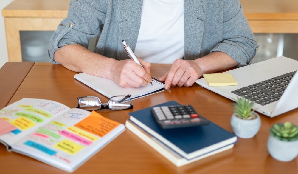 Woman writing in planner